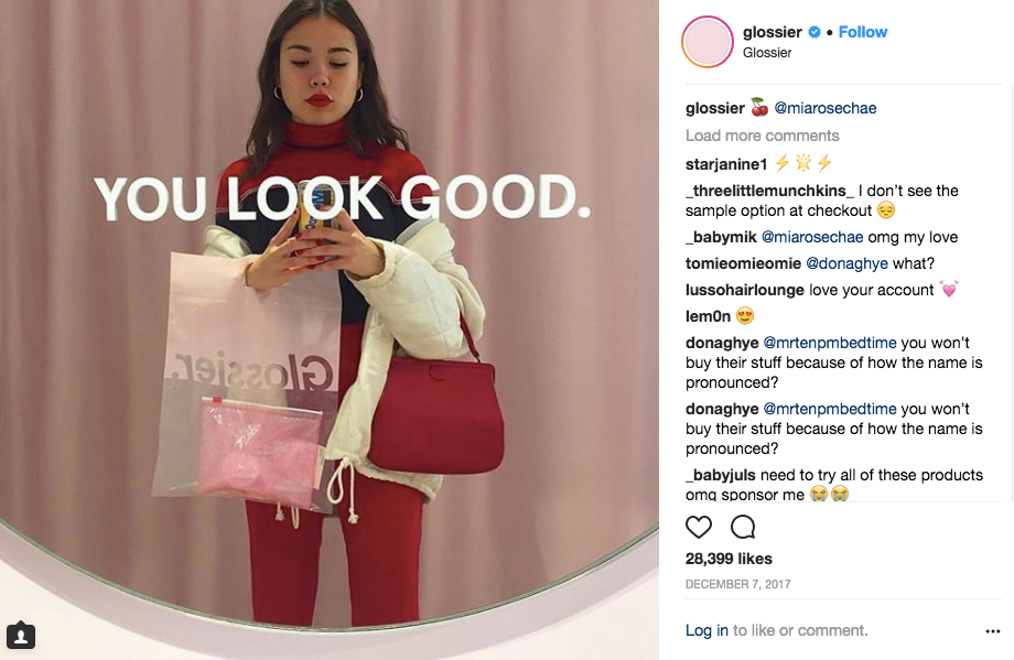 Mia Chae poses in mirror for selfie at Glossier store
