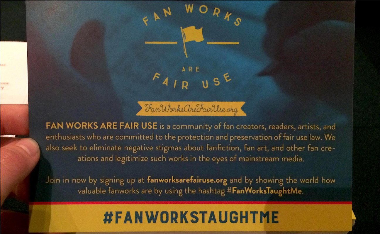 Image of a Fanworks are fair use promotional card. The text on the blue and yellow card reads: