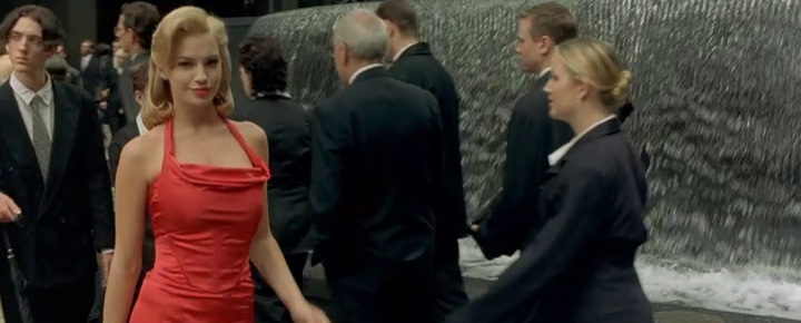 A woman in a red dress walks down a New York street