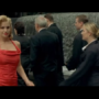 A woman in a red dress walks down a New York street