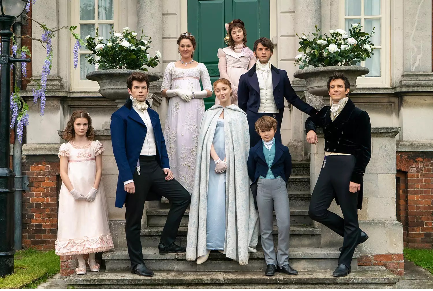 The eight Bridgerton siblings and their mother Violet in front of their home