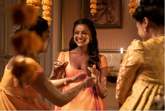 Kate, her sister Edwina and their mother face each other while performing a Haldi ceremony