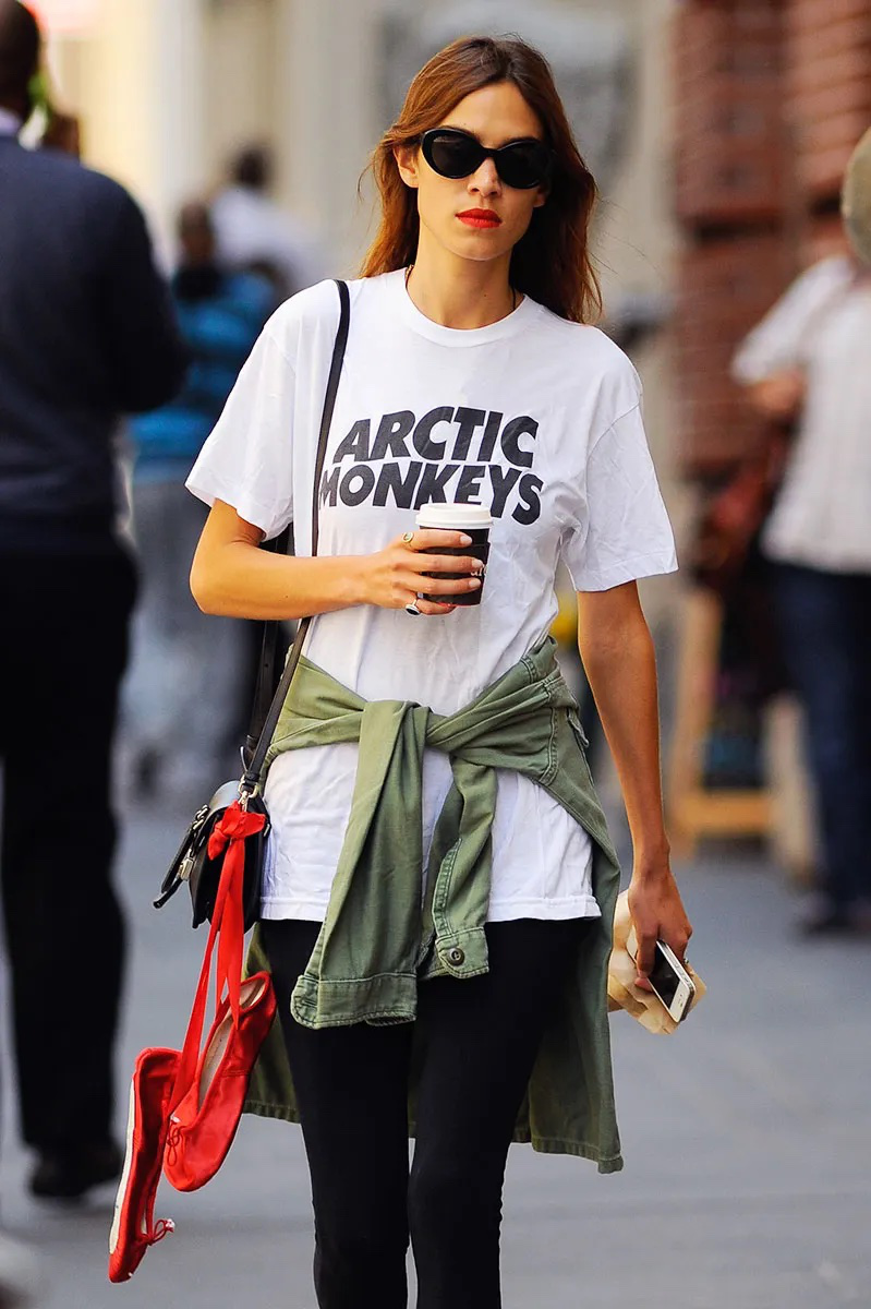 Alexa Chung wearing an Arctic Monkeys t-shirt and black sunglasses.