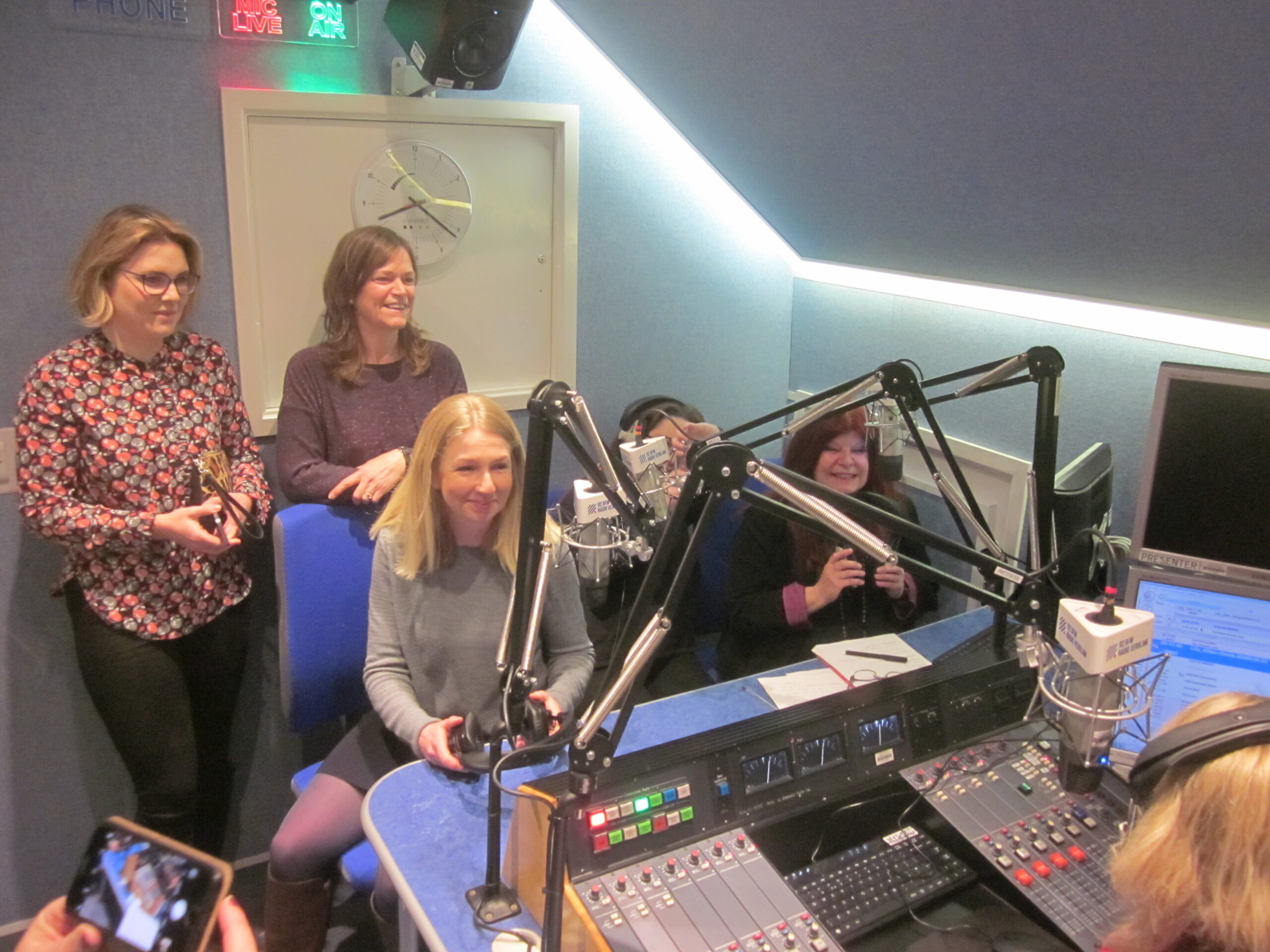 An image of radio guests in an audio booth.