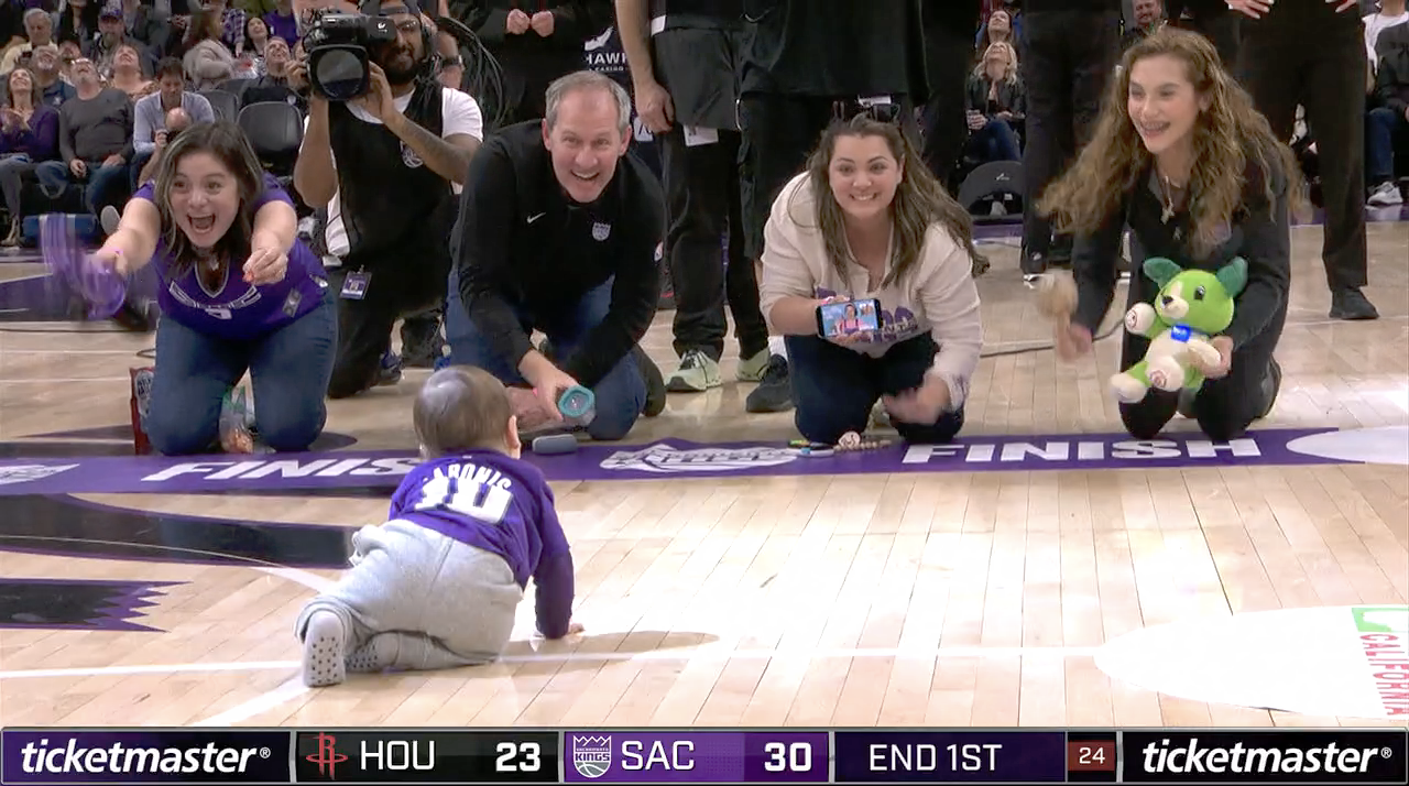 Fans participate in a “baby race” during a Sacramento Kings home game