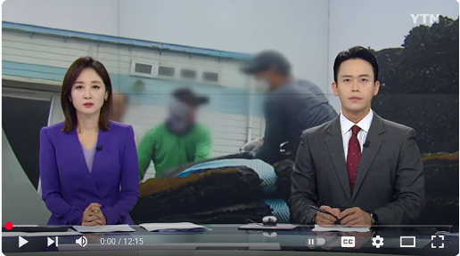 Two newscasters sitting in front of an image of human rights violation