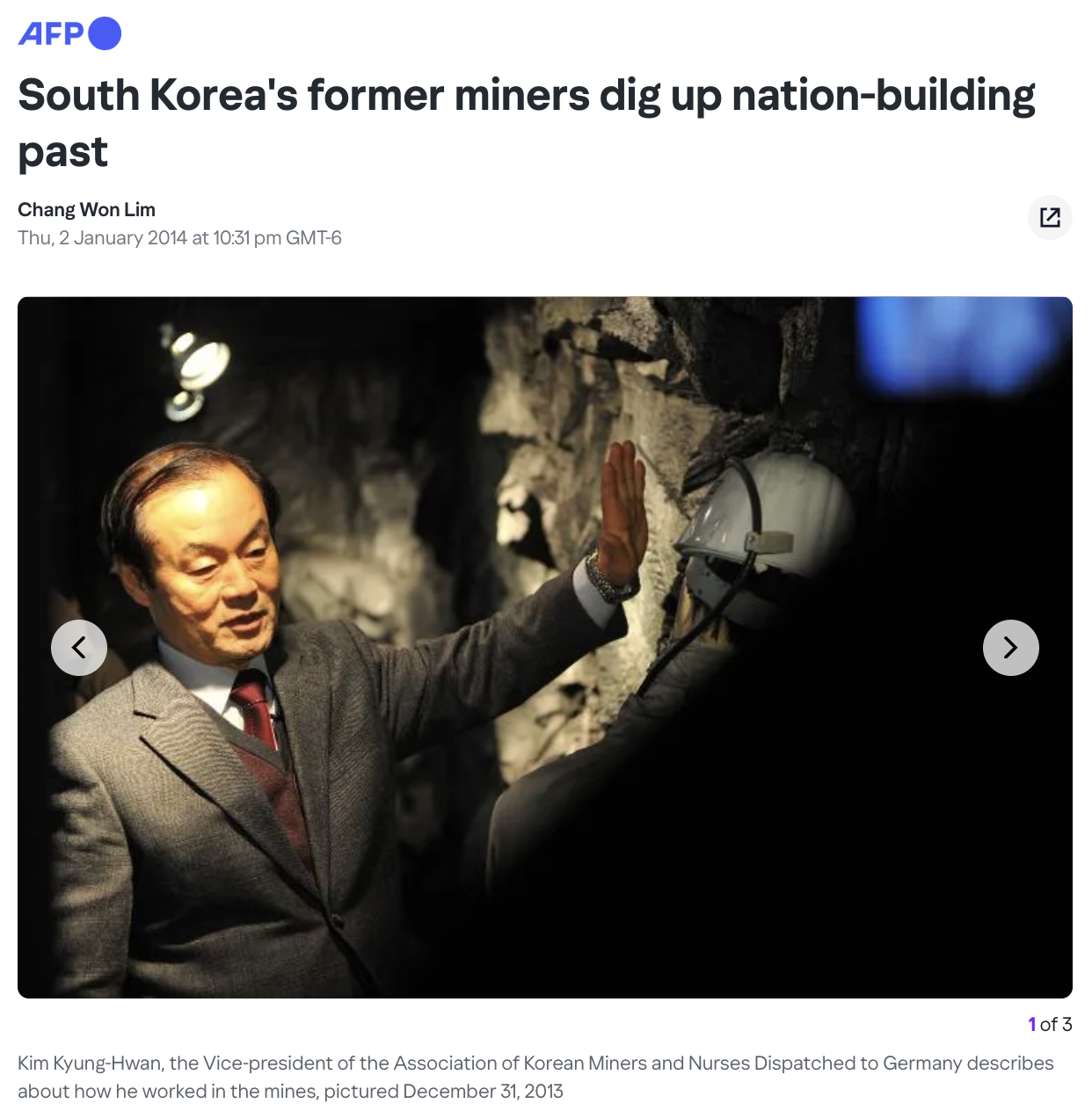 South Korean man standing in a mine and motioning to the wall