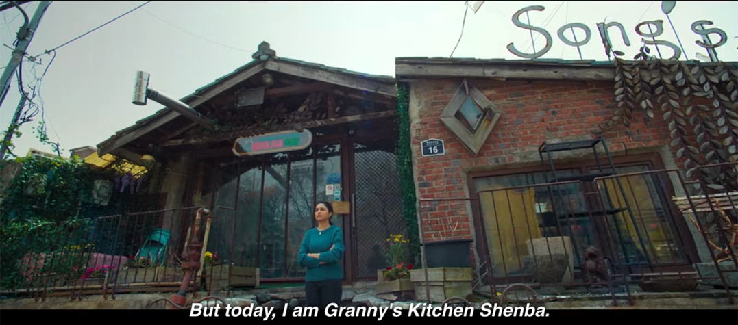 A girl standing in front of a restaurant